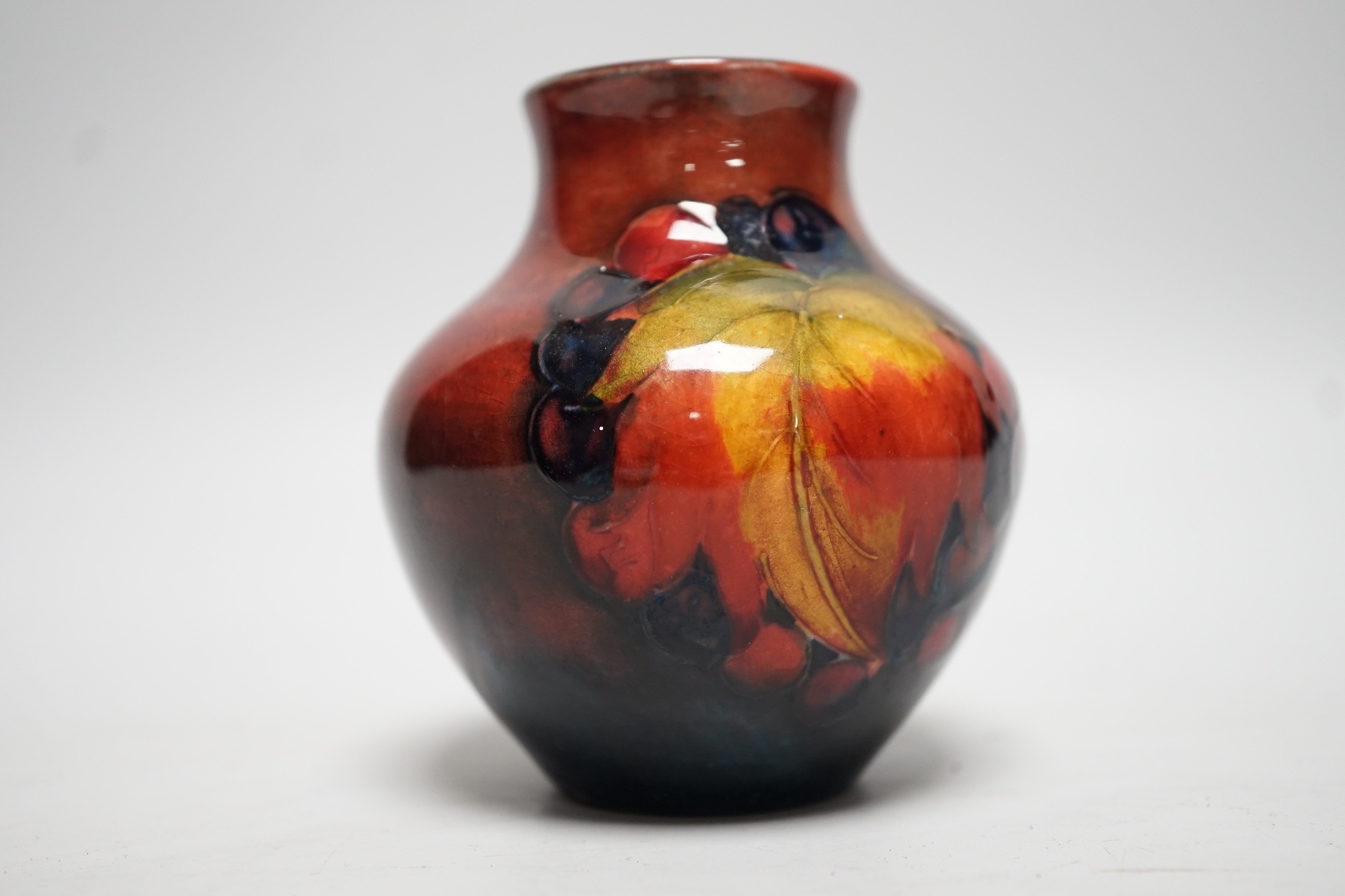 A Moorcroft flambé leaf and berry vase, 8cm